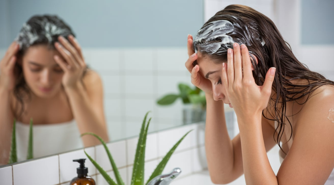 Applying a scalp mask with aloe vera and tea tree oil for nourishment and scalp health